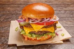 Catering 37 All-American Burger with two beef patties, American cheese, lettuce, tomato, pickles, red onion, bark + bite sauce, and a side of fries.