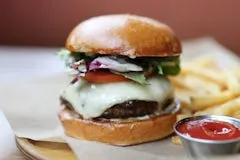 Catering 39 Bison Burger with fries, made with bison and wagyu beef, havarti cheese, caramelized onion bacon jam, lettuce, tomato, and mayo.
