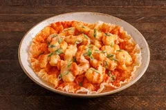 Catering 67 Firecracker Shrimp wok-tossed with ginger, garlic, and spicy firecracker sauce, served over crispy rice paper and topped with green onions.