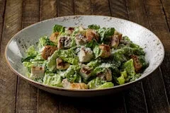 Catering 48 Grilled Chicken Caesar Salad with crisp romaine, garlic croutons, parmesan, and creamy Caesar dressing.