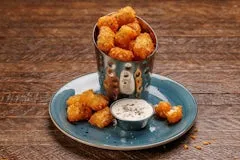 Happy Hour 19 Lemon Pepper Tots seasoned with zesty lemon and pepper, served with housemade buttermilk ranch.