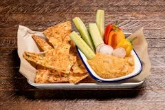 Happy Hour 15 Roasted Pepper Hummus served with fresh veggies and garlic parmesan crisps.