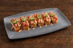 Catering 64 Spicy Tuna Crispy Rice topped with sashimi-grade tuna, spicy garlic crunch, guacamole, umami sauce, fresh jalapeños, and furikake.