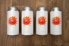 Happy Hour 29 Sunspanked Red 4 Pack containing four cans of Irish-style red ale featuring a bright red sun face logo with orange rays.