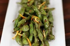 Happy Hour 25 Togarashi Edamame Beans tossed with sea salt, chili flakes, garlic, ginger, and orange peel.