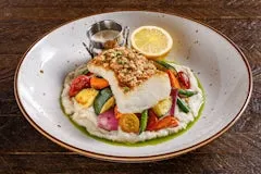Home 102 Wild caught sea bass plated dish on restaurant menu