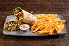 Home 24 Flour tortilla wrap filled with shawarma-seasoned roasted chicken, mixed greens, tomato, red onion, cucumber, hummus, feta cheese, roasted red pepper, crispy garbanzo beans, served with fries and dipping sauce