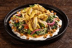 Home 20 Shawarma-seasoned roasted chicken, mixed greens, tomato, red onion, cucumber, hummus, feta cheese, roasted red pepper, and crispy garbanzo beans served in a fresh salad bowl