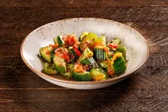 Home 23 Chilled cucumber slices marinated with spicy chili garlic seasoning, rice wine vinegar, bell peppers, and sesame seeds